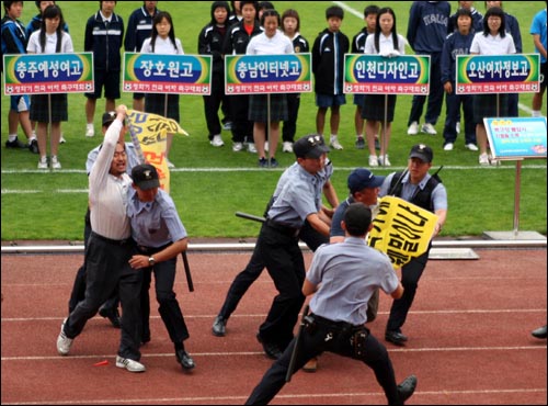 15일 청학기 전국여자축구대회 개막식 도중 강릉MBC 노조원들이 기습시위를 벌여 경찰의 제지를 받고 있다. 